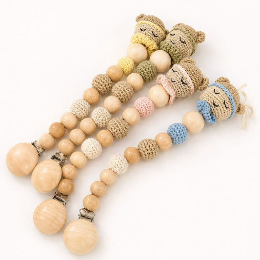 Three baby pacifier clips with wooden beads, knitted bear faces, and metal clips, displayed on a clean white background.