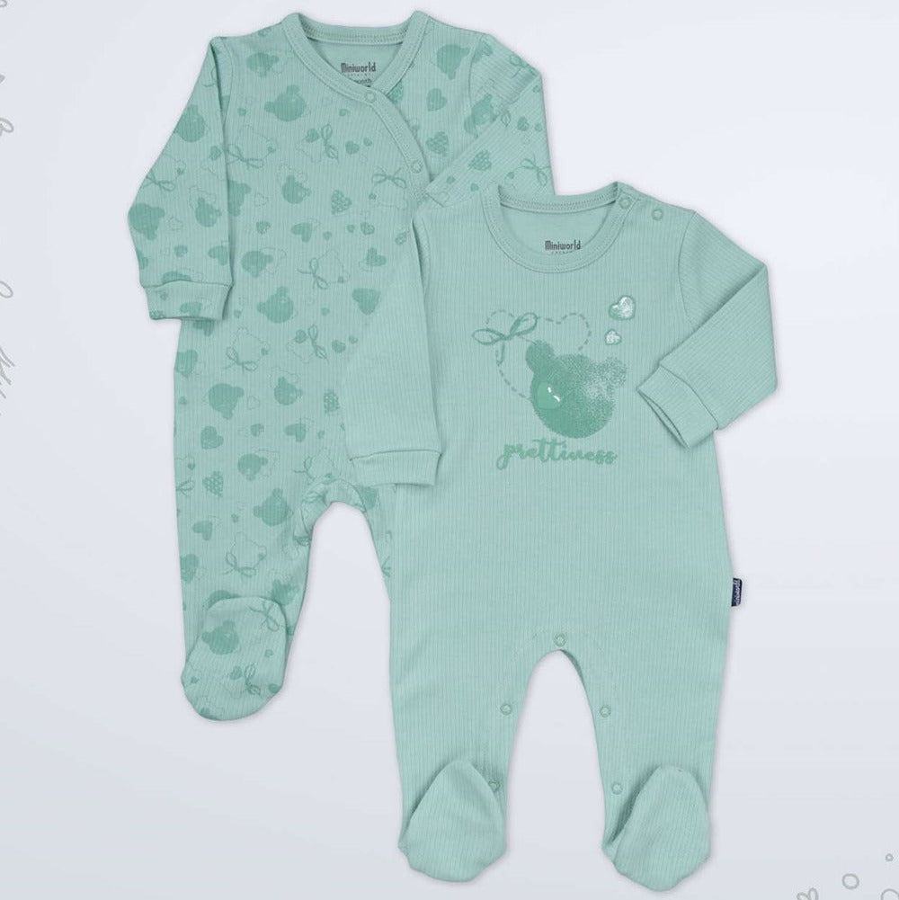 A two-piece baby sleepwear set in mint green, featuring a long-sleeve footed sleeper with a heart pattern and a matching long-sleeve bodysuit with a bear graphic and the word 'petit'.