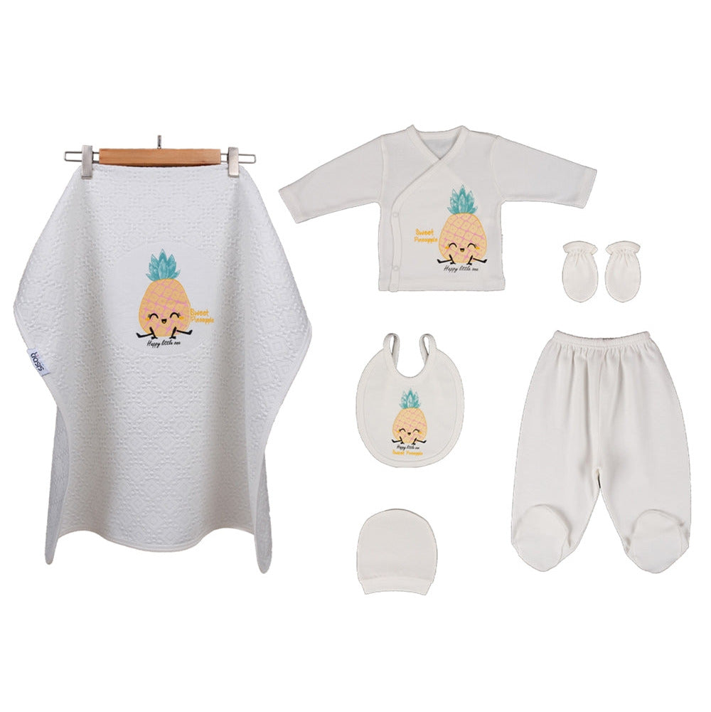 A baby clothing and textile set laid out on a white background, including a white waffle-knit bib, a white long-sleeve top, white footed pants, white mittens, a white beanie, and a white muslin wrap with a pineapple graphic.