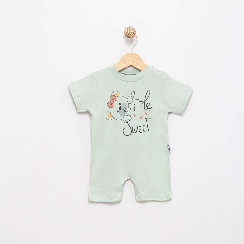 A baby short-sleeve romper in pale mint green, hanging on a wooden hanger against a plain white wall. The front features a cute cartoon dog graphic with a red bow and the text 'Little Sweet' in black script.